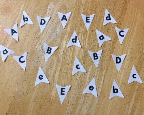 paper shark teeth with letters on table