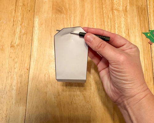 screwdriver making hole in paper